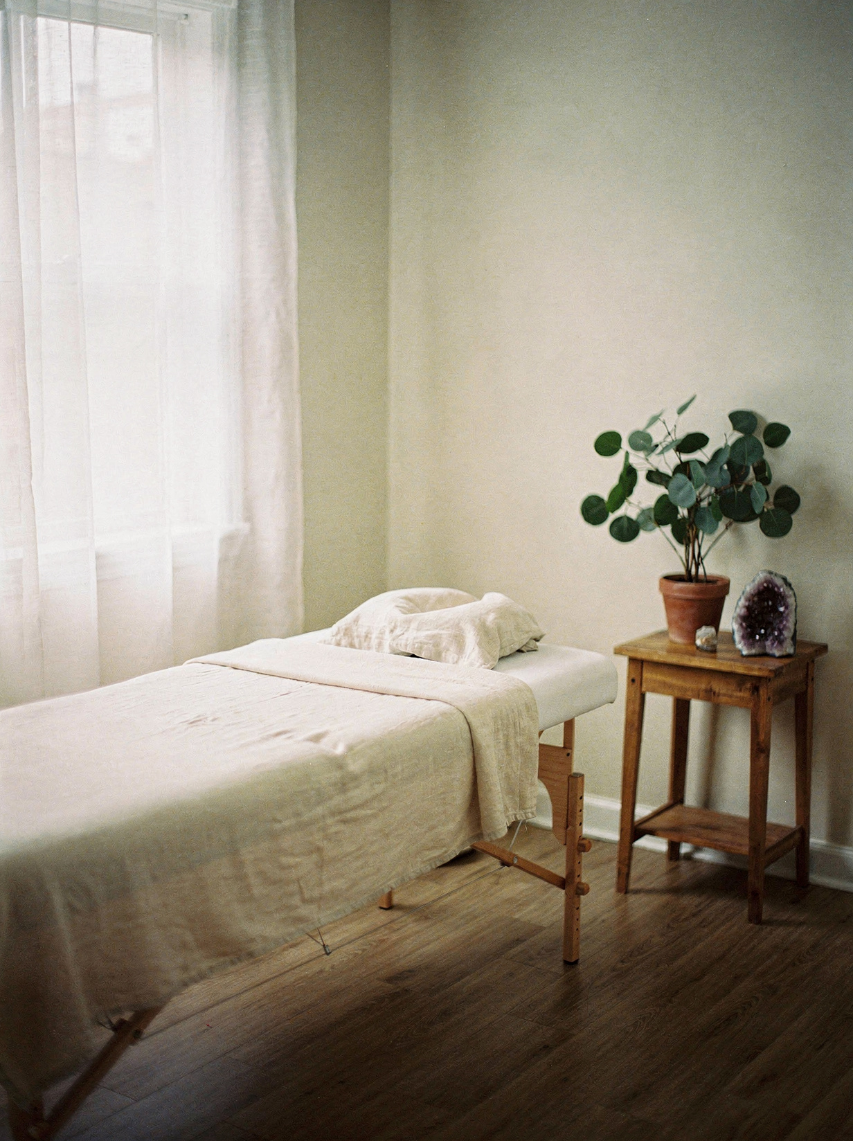 Serene Reiki treatment room with massage table, linen, and soft morning light